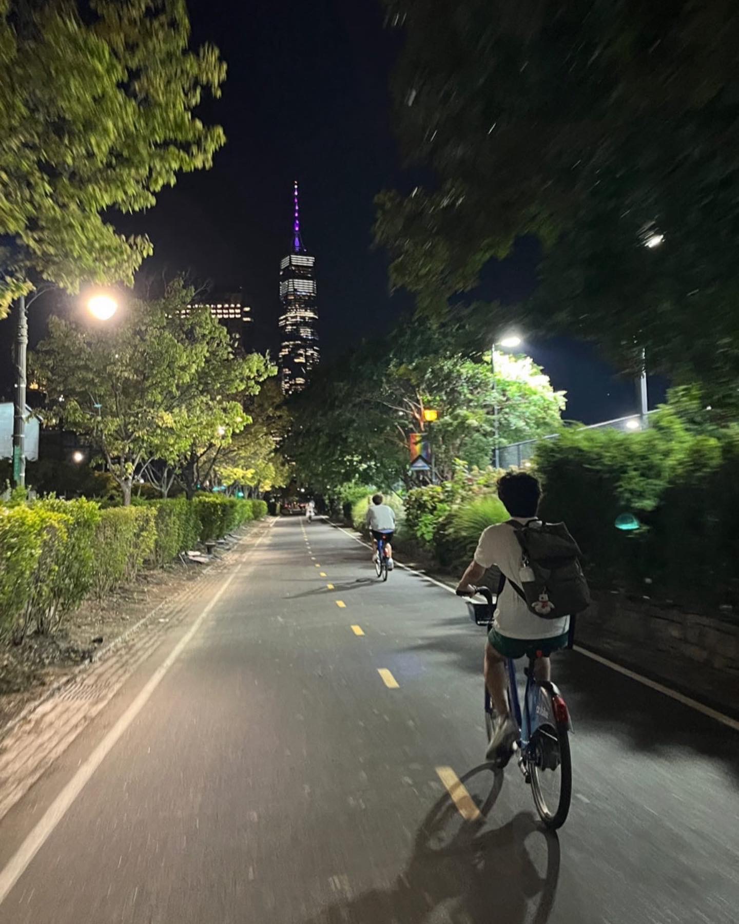 Nighttime bike ride on the Hudson River Parkway with a view of One World Trade Center 